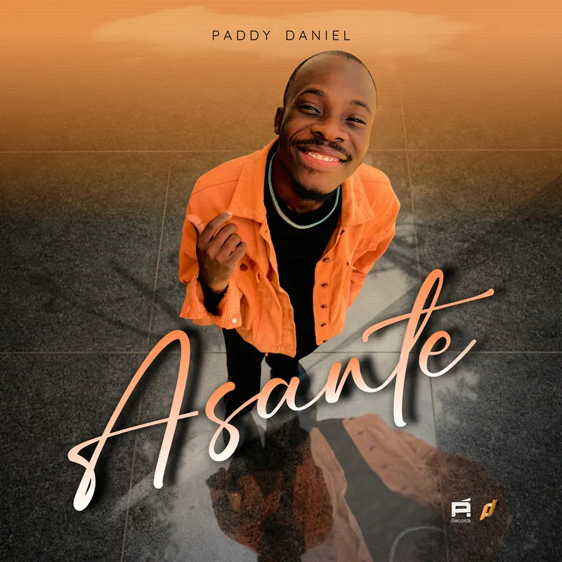 Asante single cover: Paddy Daniel smiling in an orange jacket