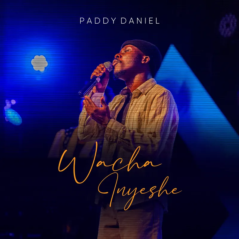 Wacha Inyeshe cover: Paddy Daniel singing under blue stage light